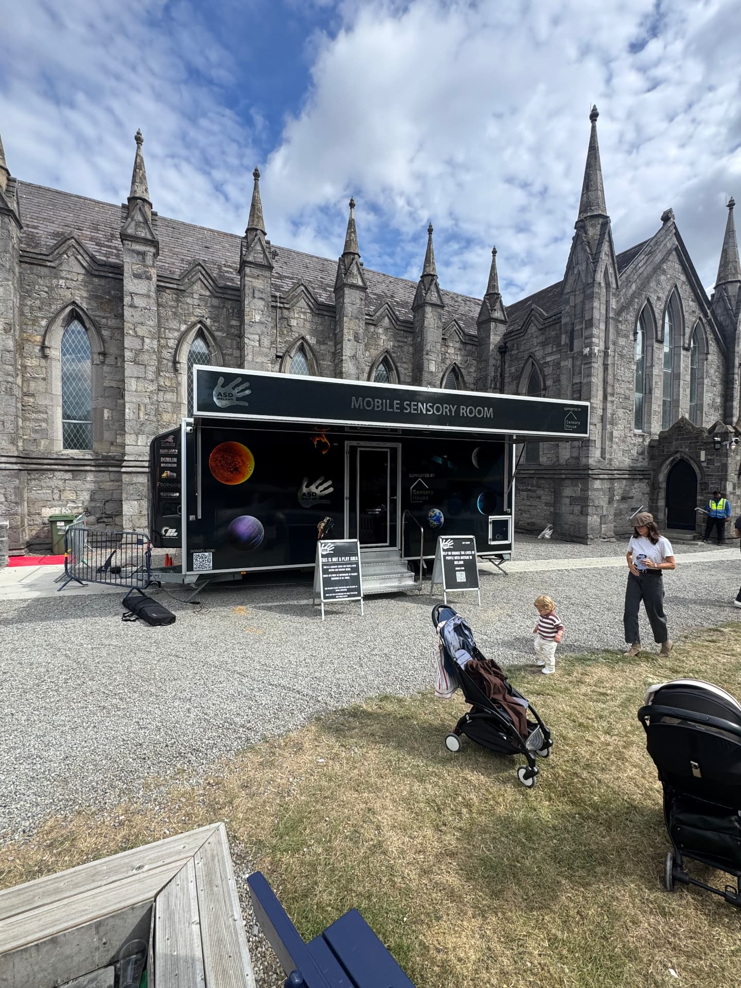 The ASD Ireland mobile sensory room trailer on the RDS showgrounds, with families nearby.