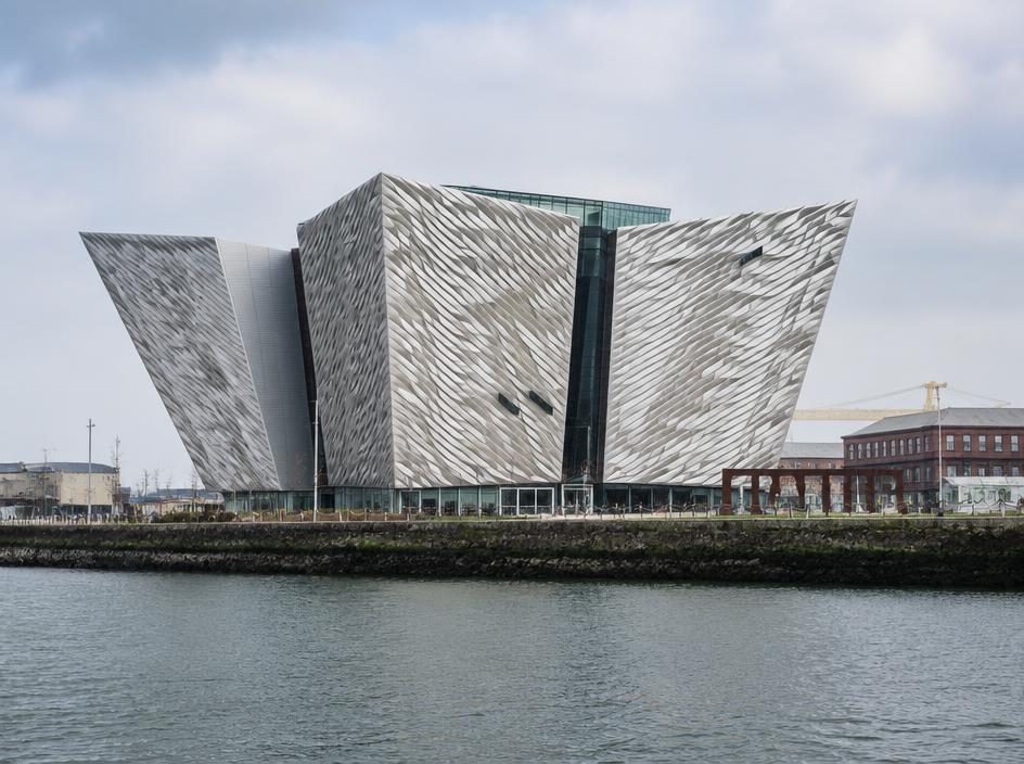 A modern silver-clad museum building on the Belfast dockside.